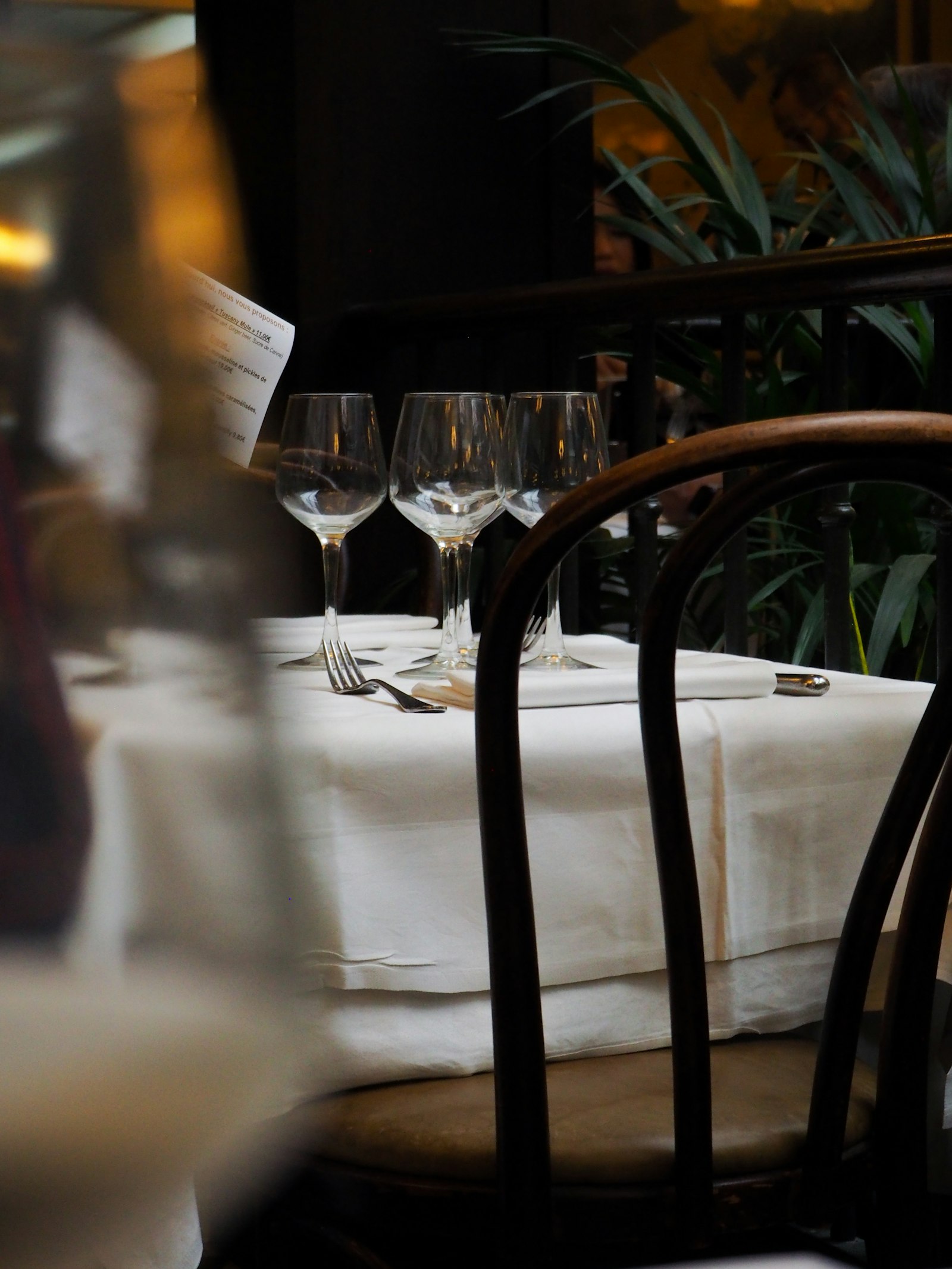 A candlelit table set with wine glasses at El Niguel Country Club's Main Dining Room
